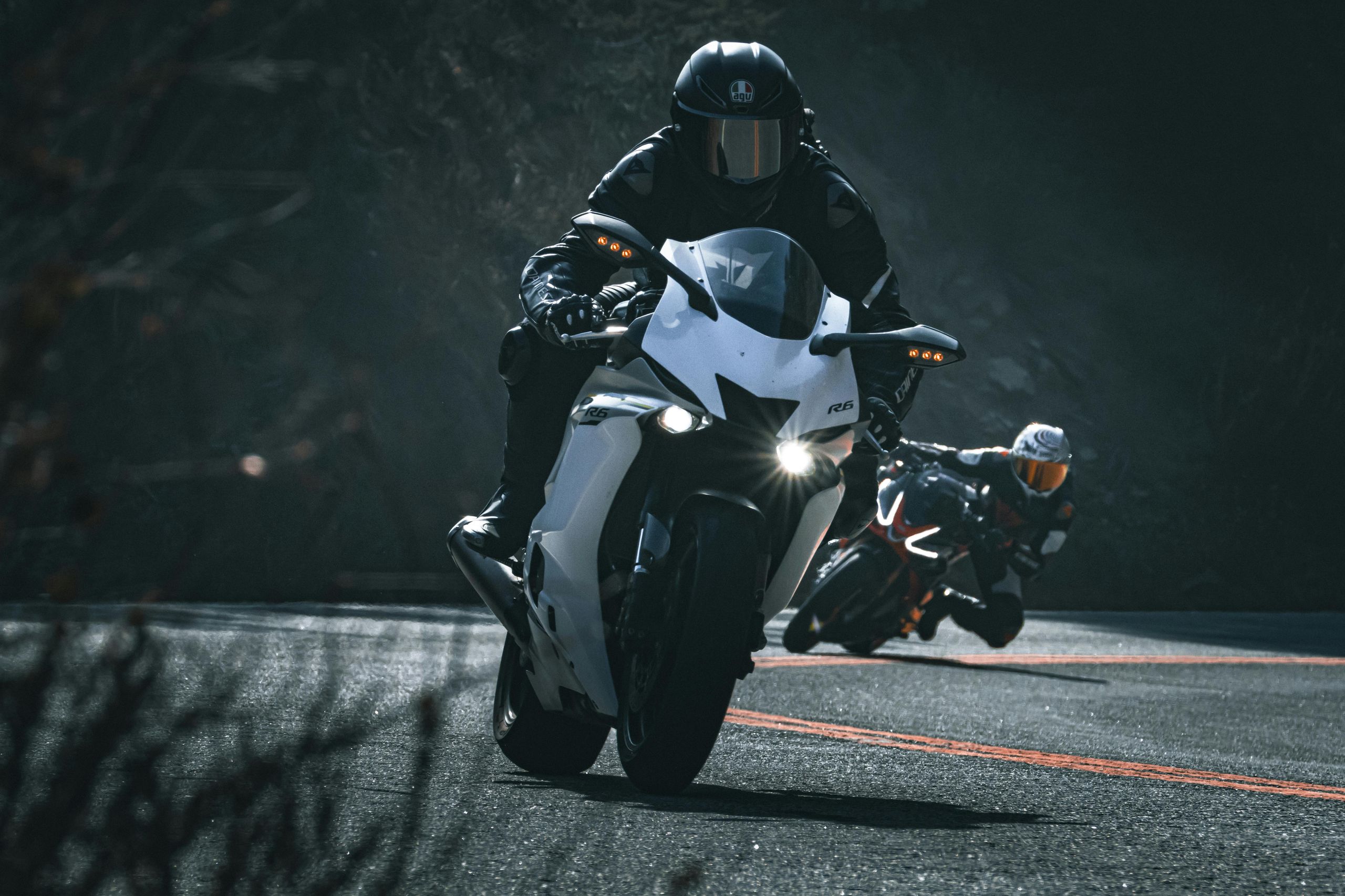 Motorcycles racing on a winding road